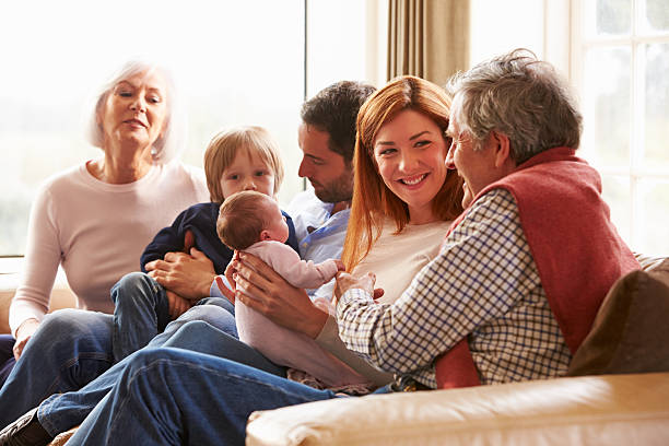 Mother ,father ,daughter ,grandmother ,grandfather on bed with baby