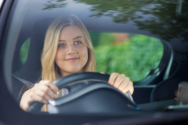 istock young woman driving her car 510040319