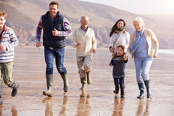 istock Multi Generation Family Running On Winter Beach 510040973