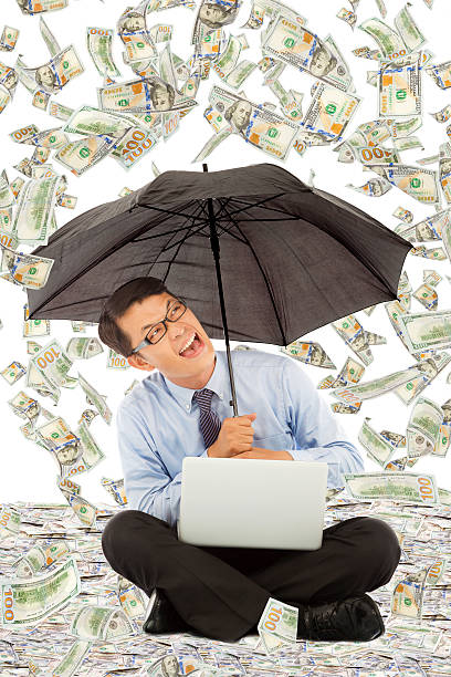 istock happy business man sitting on floor with us dollar rain 510040981
