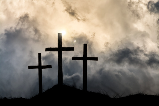 An other worldly sky overshadows the crosses symbolizing Christ's victory and ascension into heaven.