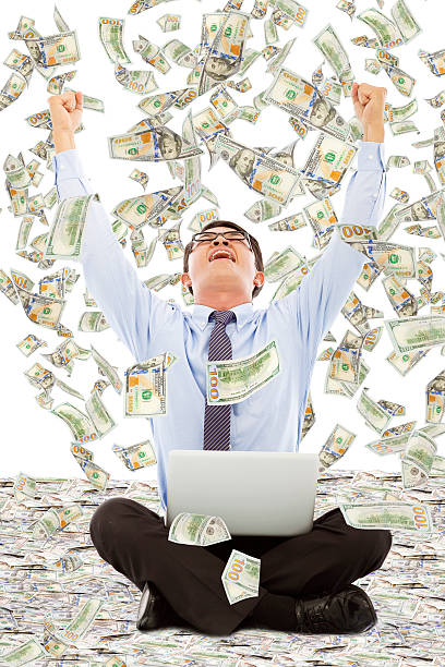 istock exciting young businessman raise hands with money 510041407