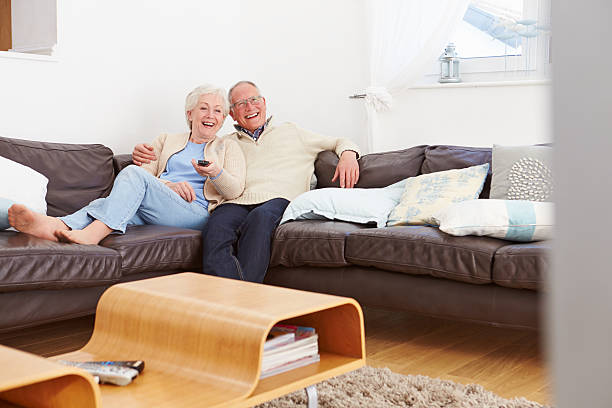istock Senior Couple Sitting On Sofa Watching TV 510041481