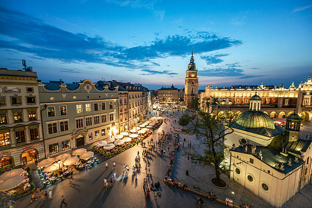 Krakow Market Square, Poland A view of the market square in Krakow at sunset wawel cathedral photos stock pictures, royalty-free photos & images