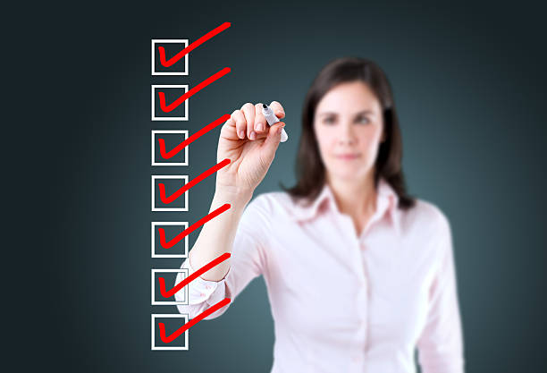istock Young business woman checking on checklist boxes. 510042249