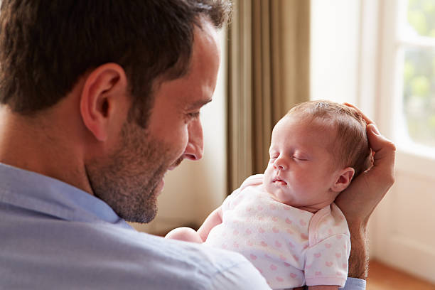 istock Father At Home With Sleeping Newborn Baby Daughter 510042343