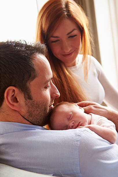 istock Parents At Home With Sleeping Newborn Baby Daughter 510042379