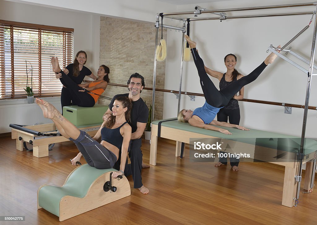 Pilates Studio Ladies learning how to make pilates with instructors Activity Stock Photo