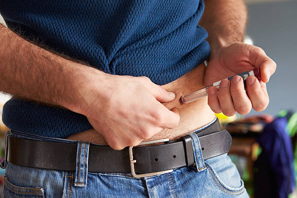 macho diabéticos la inyección de ellos con insulina - insulin fotografías e imágenes de stock