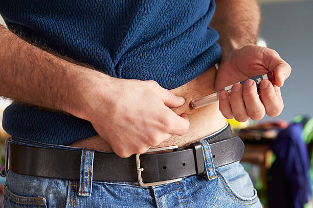 Male Diabetic Injecting Themselves With Insulin Male Diabetic Injecting Themselves With Insulin insulin stock pictures, royalty-free photos & images
