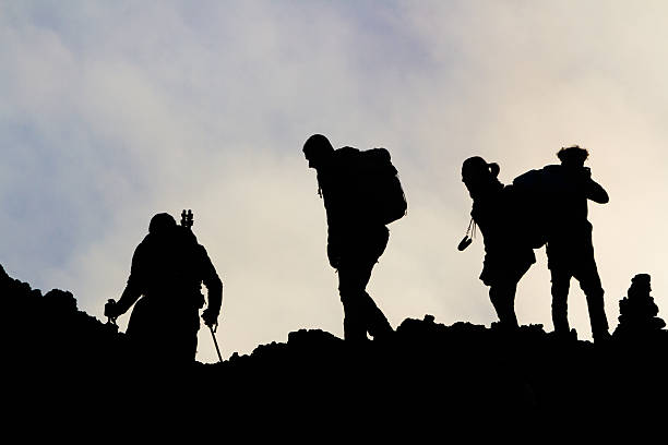 istock silhouettes of men on the volcano Etna 510043507