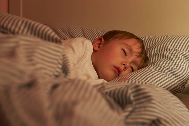 istock Young Boy Asleep In Bed At Night 510043649