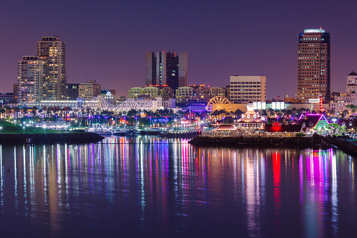 Long Beach Rainbow Harbor at dusk with the downtown and the port in the background.
