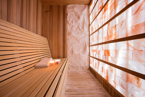 Salt room made of wood with walls made of salt. Halotherapy is a form of alternative medicine. Photo taken under the available light from glowing wall. 
