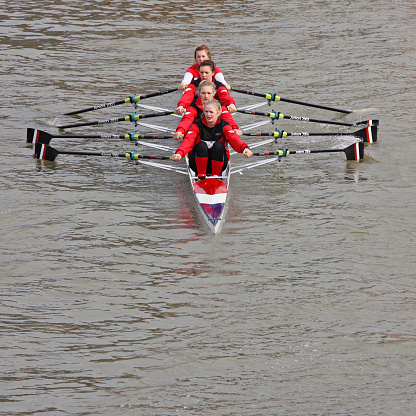 Bristol, England - February 20, 2011: Team of young women rowing to the start point of the annual river race through Bristol docks
