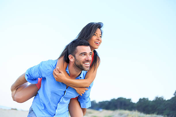istock Young couple enjoying piggyback on the beach 510057794