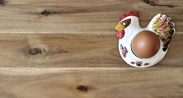 egg in an egg holder on a wooden table