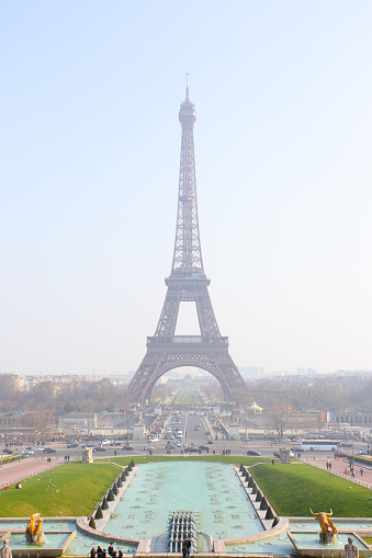 Paris, France - April 12, 2012: The Eiffel Tower on a bright sunny day shot low down from the grass of the Parc du Champs-de-Mars