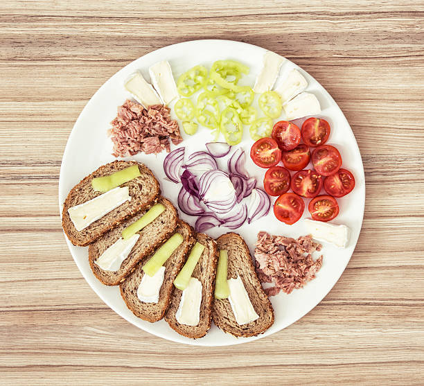 istock Sliced whole wheat bread with cheese, paprika, tuna, onion 510059576