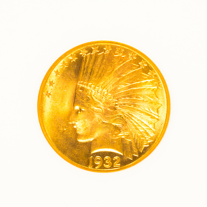 Gold indian head coin isolated on white background.