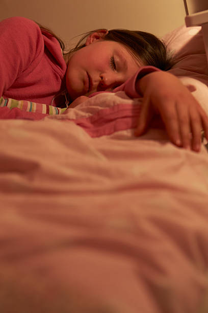 istock Young Girl Asleep In Bed At Night 510063045