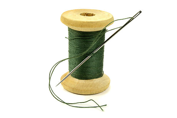 istock Wooden coil with threads and needle on a white background 510063484