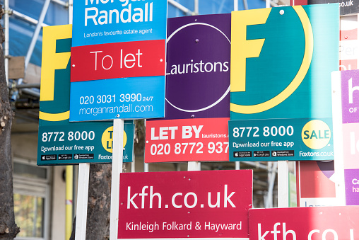 London, England, United Kingdom - October 31, 2015: For Sale, To Let and Sold, Estate Agency advertising hoarding boards outside residential housing in Balham, South London.