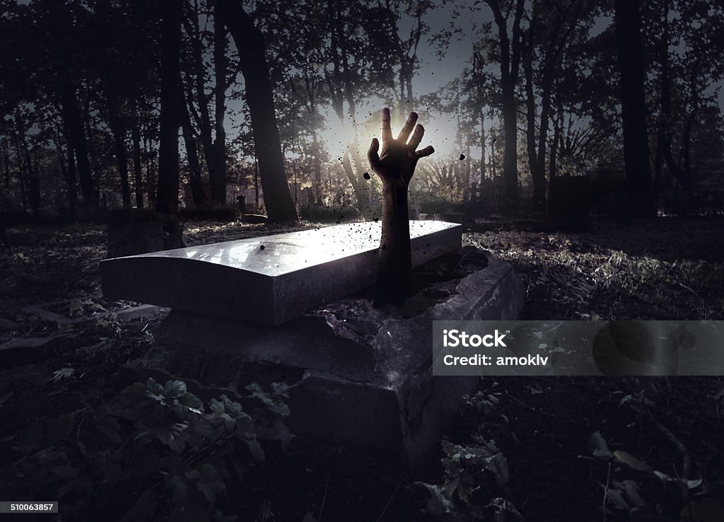 Hand rising out from the grave Grave Stock Photo