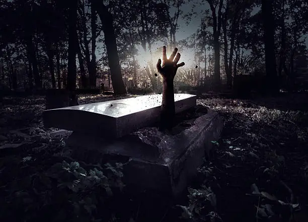 Photo of Hand rising out from the grave
