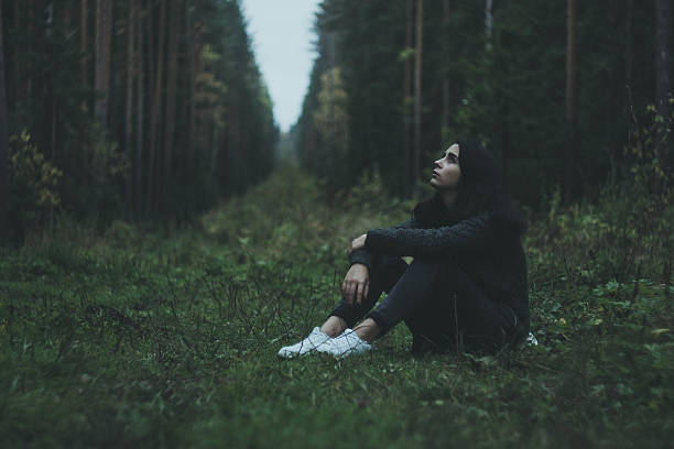 istock The girl thoughtfully sitting in the woods 510064302