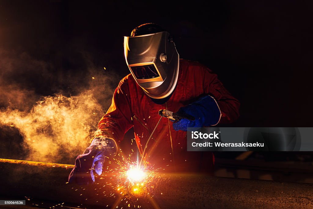 Industrial Worker Industrial Worker at the factory welding closeup Steel Mill Stock Photo