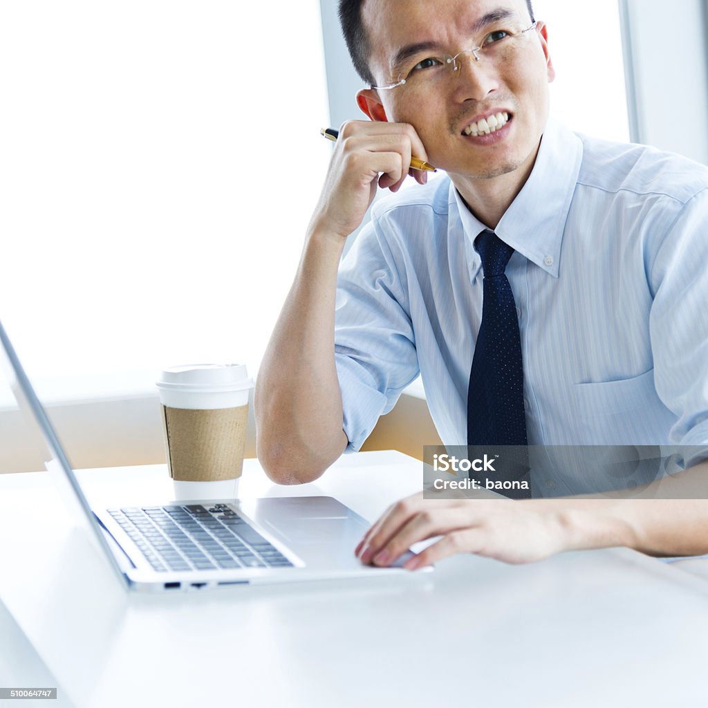 using laptop Asian businessman working on his laptop. 30-39 Years Stock Photo
