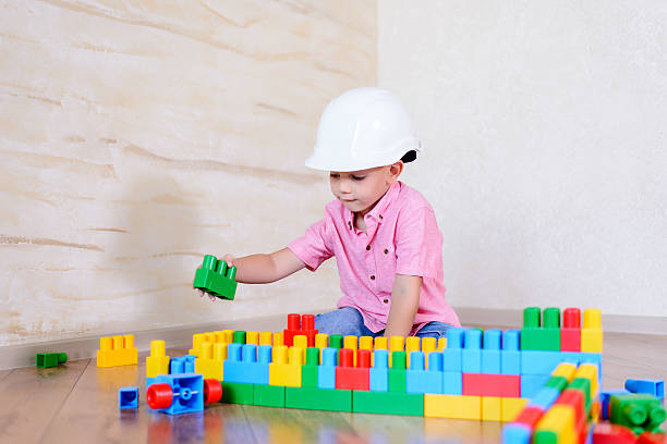 istock Young boy wearing hardhat playing indoors 510065056