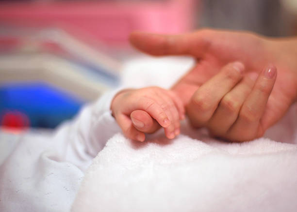 istock Baby hand holding her mother finger 510065426