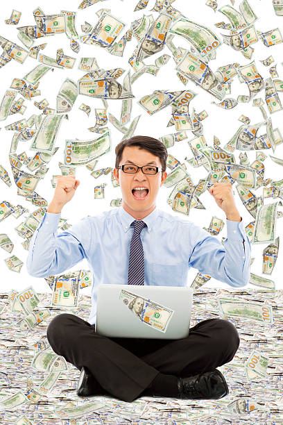 istock business man make a victory gesture with money rain 510065933
