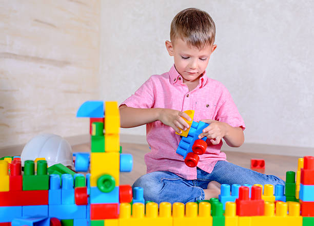 istock Young boy playing with colorful building blocks 510066190