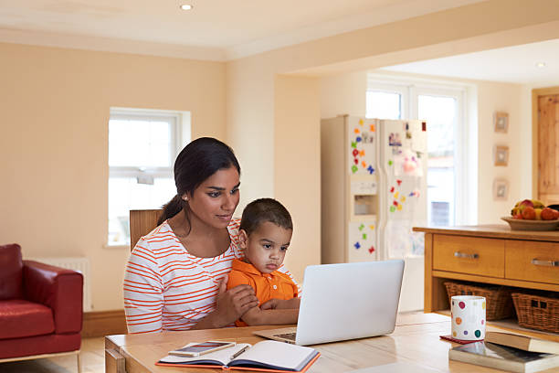 istock Mother And Son In Kitchen Looking At Laptop Together 510066324