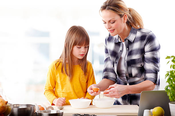 istock Mother and daugther baking together 510066508