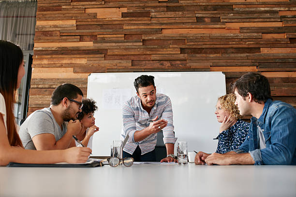 istock Young man with colleagues discussing new project 510066674