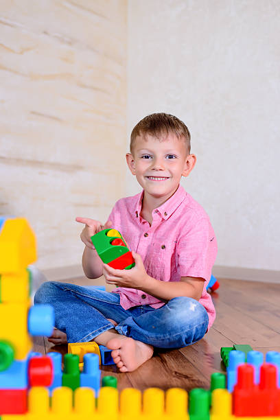 istock Happy young boy playing with his building blocks 510066976