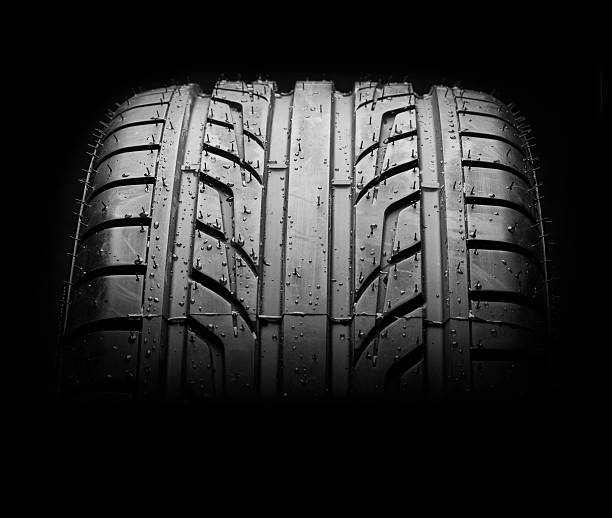 istock Wet car tire on black macro 510067003