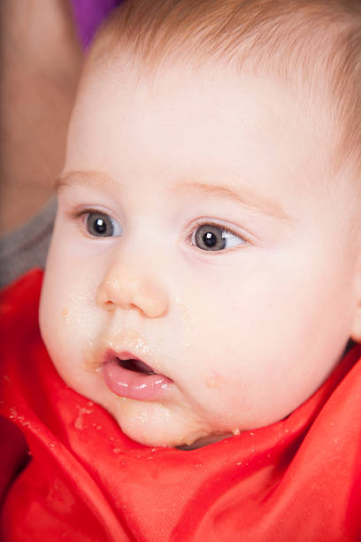 istock open eyes and mouth baby eating 510067338