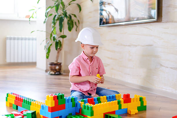 istock Happy little boy wearing plastic white hard hat 510067434
