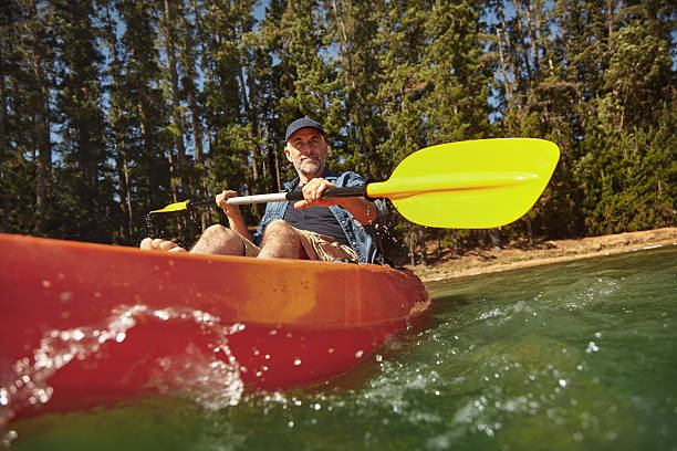 istock Mature man canoeing on summer day 510067582