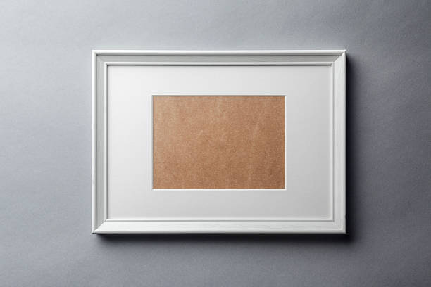 White wood frame on grey wall White plain empty wood picture frame with white mat passe-partout on grey wall background mat photos stock pictures, royalty-free photos & images