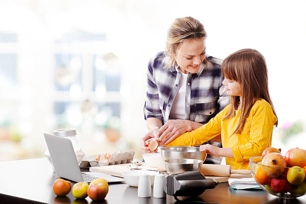 istock Mother and daugther baking together 510067792