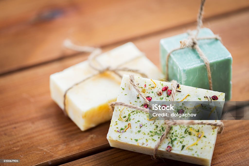 close up of handmade soap bars on wood beauty, spa, body care, bath and natural cosmetics concept - close up of handmade soap bars on wooden table Homemade Stock Photo