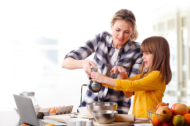 istock Mother and daugther cooking together 510069866