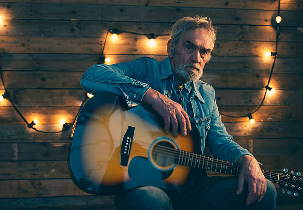 istock Senior guitarist with beard sitting on chair. 510070600