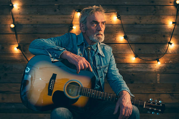 istock Senior guitarist with beard sitting on chair. 510070644